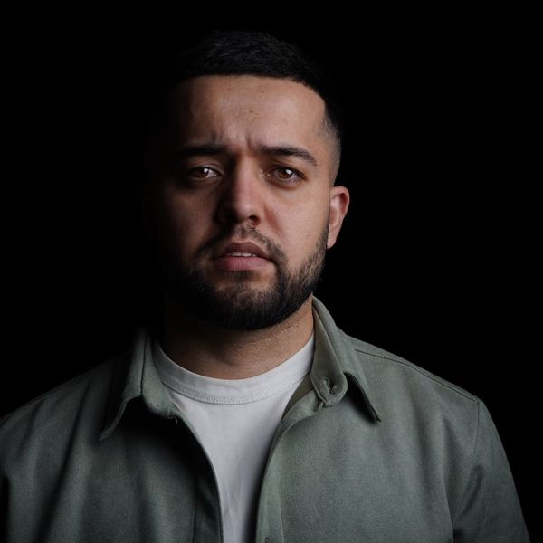 Silhouette of a man in a meditative pose against a dark, cosmic background.